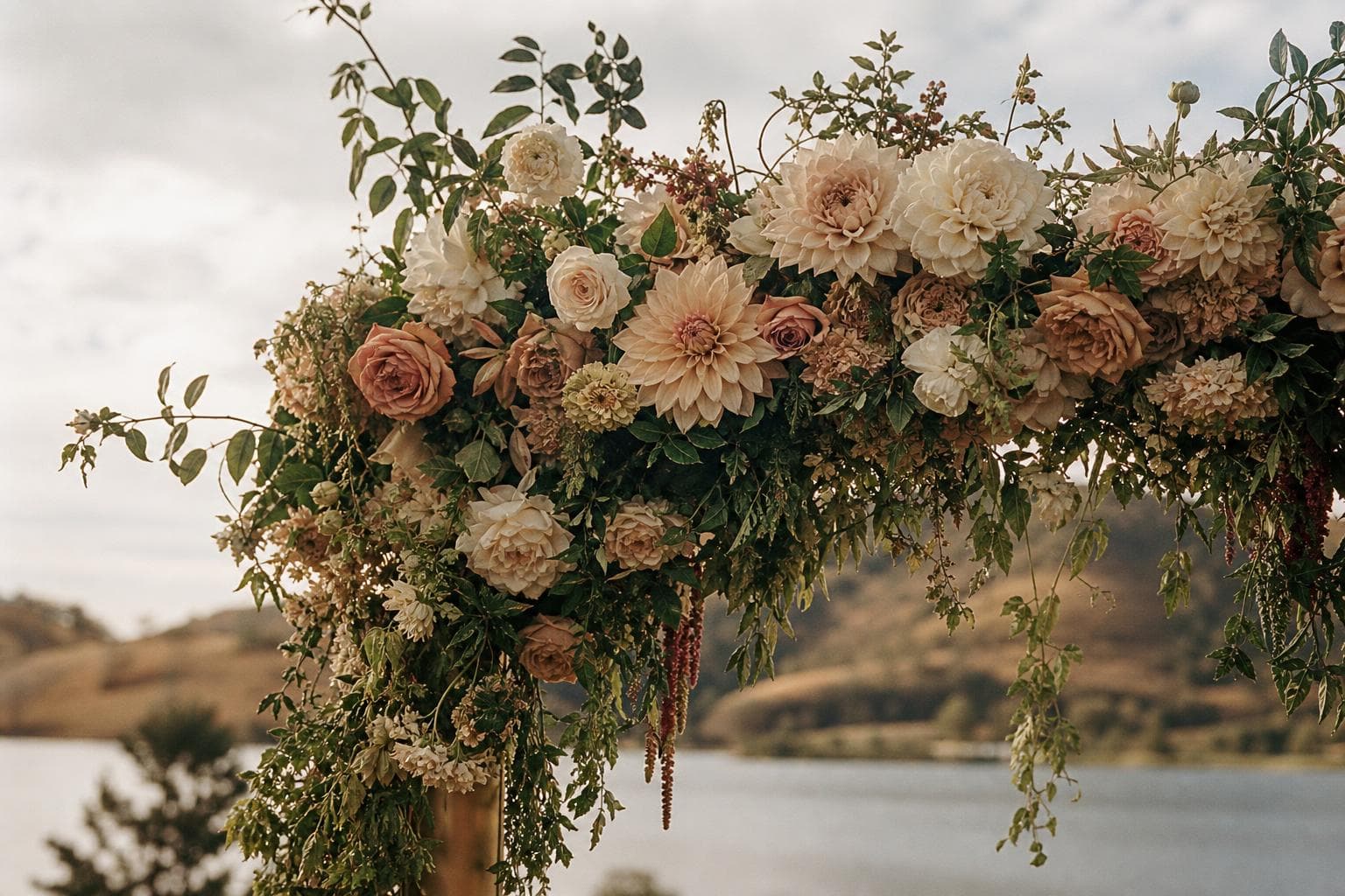A floral concept with soft cream and peach flowers and loose foliage